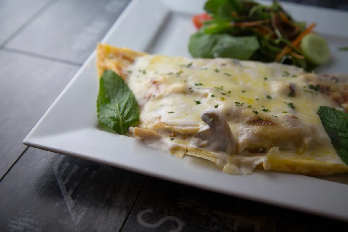 Proje: The Chef Cafe Üzerinde nane yaprağı ile süslenmiş kahvaltılık krep.